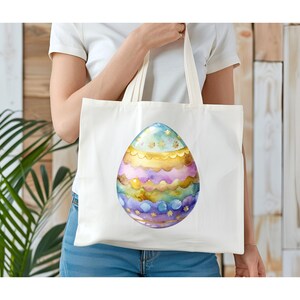 May include: A white tote bag with a colorful Easter egg design. The egg is decorated with gold, purple, blue, and green stripes and stars.