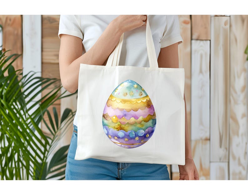 May include: A white tote bag with a colorful Easter egg design. The egg is decorated with gold, purple, blue, and green stripes and stars.