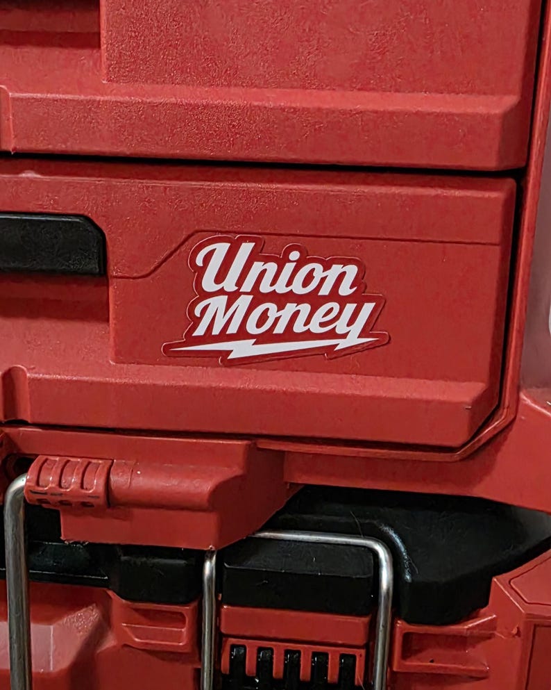 May include: Red tool box with the words "Union Money" in white script on a sticker. The sticker has a white lightning bolt design. The tool box has a black handle and metal latches.