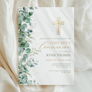 May include: A First Holy Communion invitation with a gold cross and text. The invitation features a floral design with green and gray eucalyptus leaves. The text reads "Kindly join us to celebrate the First Holy Communion of our son Ryan Thomas."