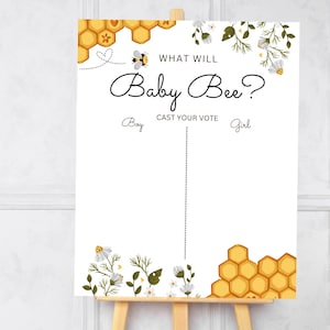 Puede incluir: Un cartel blanco con un patrón de panal y una ilustración de abeja. El cartel dice "What will Baby Bee?" y tiene un espacio para votar por niño o niña.