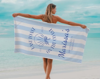 May include: A blue and white striped beach towel with the text "Last Toast on the Coast" and "Marissa's Bachelorette Weekend" in navy blue. A seashell graphic is also featured.
