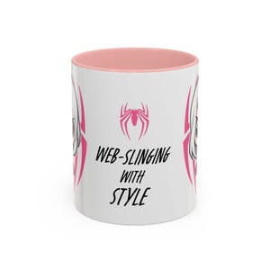 Center-Pink Mug-Spider-Gwen (Ghost-Spider) mug featuring a graphic of Spider-Gwen in her iconic white and pink suit. The design includes the phrase 'Web-Slinging with Style' in bold text, Perfect for Marvel fans and Spider-Gwen enthusiasts.