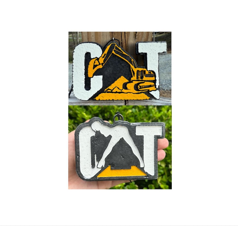 May include: Two rectangular hanging ornaments featuring the letters CAT. The top ornament displays a yellow excavator graphic integrated into the letter A. The bottom ornament features a white silhouette of a person in a pose within the letter A.