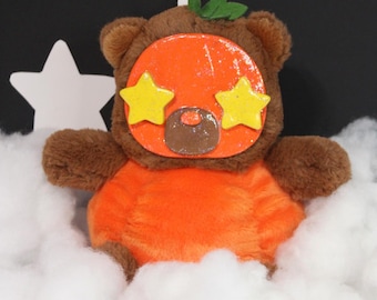 Peluche de calabaza con cara de arcilla