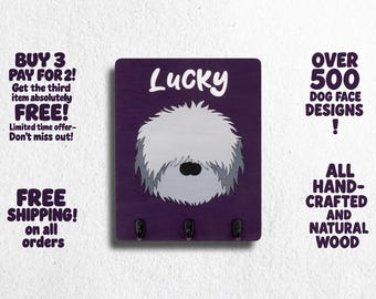 May include: Purple wooden key holder with a white dog silhouette and the name "Lucky" printed in white. The key holder has three hooks.