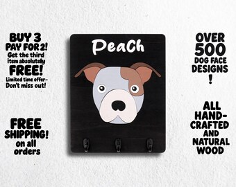 May include: Black wooden key holder with three hooks. The key holder features a cartoon illustration of a dog's face with the word "Peach" above it.