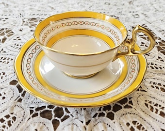 Royal Albert Crown China yellow and gold teacup and saucer set