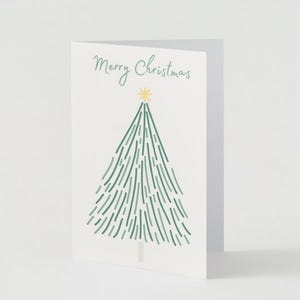 May include: A white Christmas card with the text "Merry Christmas" and a green stylised Christmas tree with a yellow star on top.
