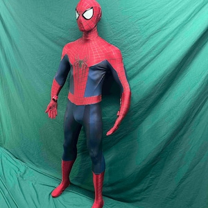 May include: A full-body superhero costume featuring a red and blue color scheme with a black spider web pattern across the red sections. The suit includes a mask with large white eye lenses and a black spider emblem centered on the chest area.