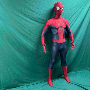 May include: A full-body Spiderman costume featuring a red and blue color scheme with a black spider emblem on the chest. The suit includes a textured fabric pattern, a full-head mask with white eye lenses, and integrated gloves and foot coverings.