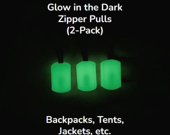Puede incluir: Tres tiradores de cremallera verdes brillantes sobre cordones negros. La imagen incluye el texto "Glow in the Dark Zipper Pulls (2-Pack)" y "Backpacks, Tents, Jackets, etc."