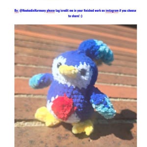 May include: A crocheted Pengullet plush toy from Palworld featuring a blue body, white face, yellow beak and feet, and a red circular patch on the chest. The text PENGULLET PALWORLD PATTERN and By: @HookedinHarmony please tag/credit me in your finished work on instagram if you choose to share! :) is visible.