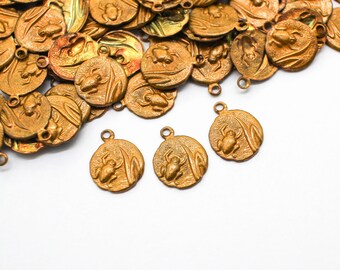 May include: A collection of antique gold-colored metal charms. Each charm is round with a raised design of a frog and aquatic plants. The charms have a small loop at the top for attaching to jewelry or other crafts.