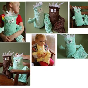 May include: A set of four plush toys in the shape of monsters. The toys are green and brown and have embroidered eyes and mouths. The toys are all different sizes and have different expressions on their faces. The toys are all lying on a wooden surface.