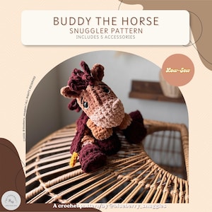 May include: A crochet pattern titled BUDDY THE HORSE SNUGGLER PATTERN INCLUDES 5 ACCESSORIES. The image features a brown and dark maroon plush horse toy with a light brown muzzle, dark eyes, and a low-sew design, created by blueberry_snuggles.
