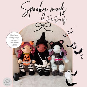 May include: Three crocheted dolls featuring Spooky mods for Everly. The left doll has orange pumpkin attire and striped leggings. The center doll wears a black witch hat and dress with a ghost bag. The right doll has a cat-ear hood and stitches.