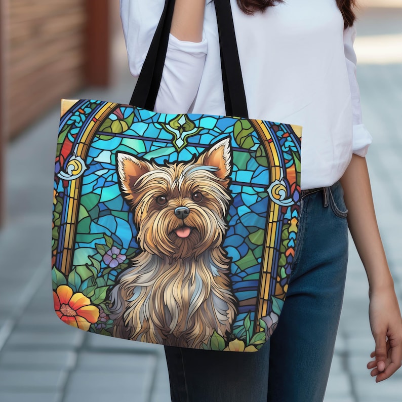 a woman carrying a handbag with a picture of a yorkshire terrier yorkie dog on it