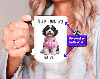 May include: White ceramic mug with a black handle. The mug features a cartoon image of a black and white dog wearing a pink sweater. The text on the mug reads "Best Dog Mom Ever" and "Love, Sophie".