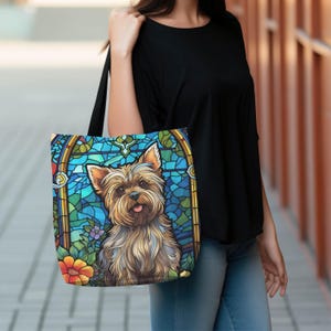 a woman carrying a handbag with a picture of a yorkshire terrier yorkie dog on it