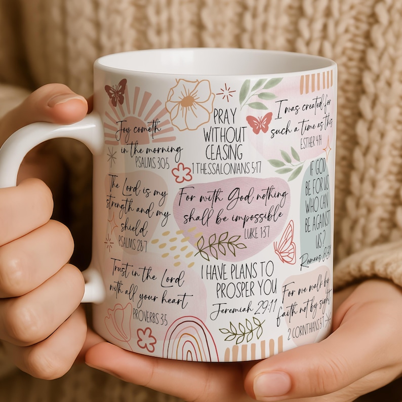May include: A white ceramic mug with a black handle and the text "But First, Coffee" in a bold, black font. The mug is filled with a dark liquid, likely coffee, and rests on a light-coloured surface.
