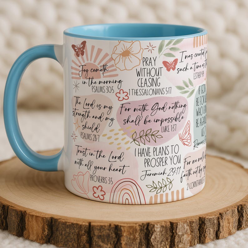 May include: A white ceramic mug with a black handle and the text "But First, Coffee" in a black, handwritten-style font. The mug is on a white surface.