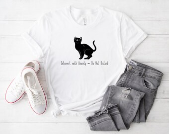 May include: White t-shirt with a black cat silhouette and the text "Introvert with Anxiety - Do Not Disturb".
