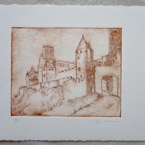 May include: A sepia-toned etching of a castle with multiple towers, walls, and arched entryways. The artwork is on textured, off-white paper. The castle is depicted with detailed lines, suggesting an old European architectural style.