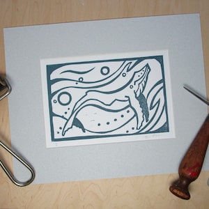 Linocut print of humpback whale