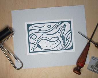 Linocut print of humpback whale