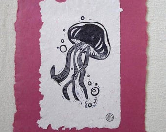 Linoleum block print of jellyfish on handmade paper