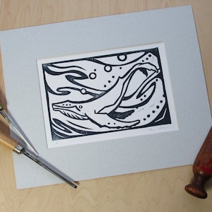 Linocut print of humpback whale