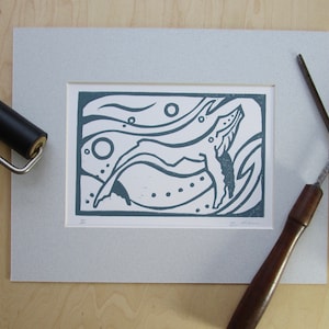Linocut print of humpback whale
