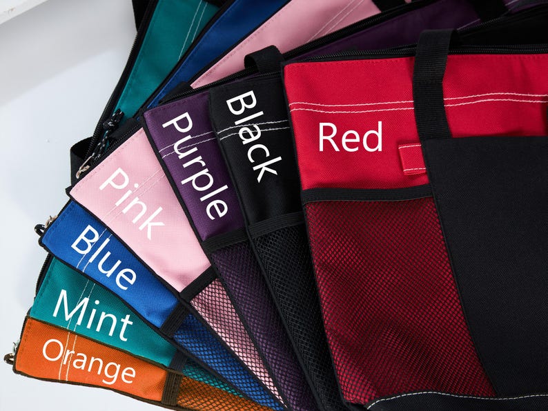 May include: A collection of tote bags in various colors, including red, black, purple, pink, blue, mint, and orange. Each bag has a mesh pocket and a label with the color name in white text.
