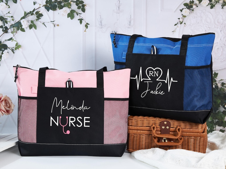 May include: Two tote bags, one pink and one blue, with black accents. The pink bag has "Melinda Nurse" printed on it, and the blue bag has a heartbeat design with "RN Jackie". Both bags have side pockets.