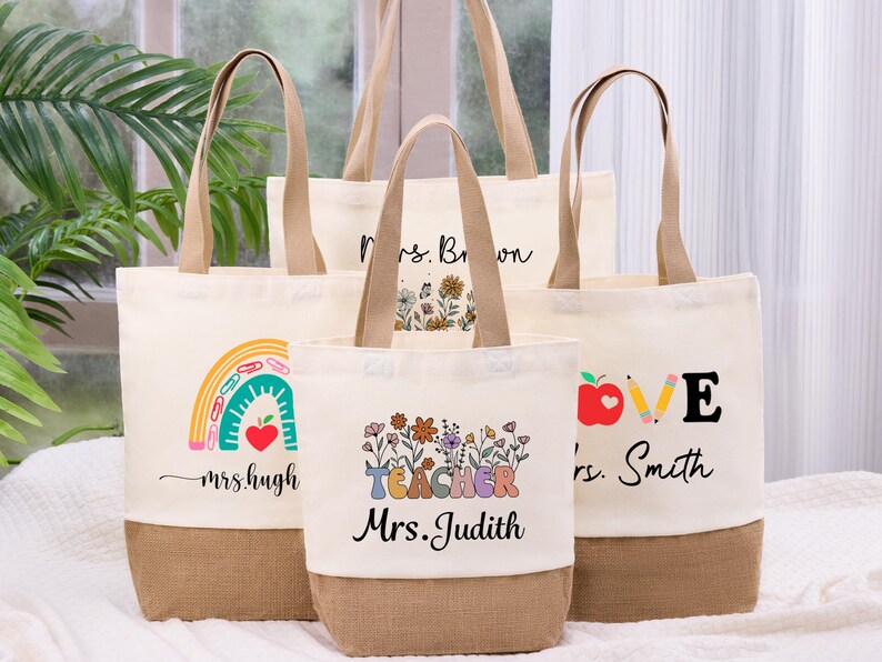 May include: A collection of canvas tote bags with various designs and text. One bag features a rainbow and the text "mrs. hugh", another says "Mrs. Brown", and a third says "LOVE mrs. Smith". The fourth bag says "TEACHER Mrs. Judith".