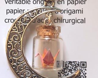 Miniature hand folded Japanese origami paper crane in mini jars dangling within silver crescent moon necklace