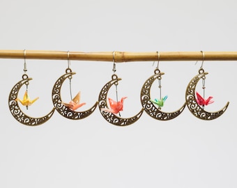 Miniature hand folded Japanese origami paper cranes encased in an ecofriendly varnish seal and dangling within bronze crescent moon earrings