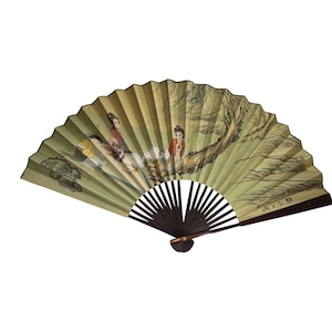 May include: A folding fan with a painted scene of figures in traditional attire. The fan features a light green background with a brown wooden handle. The artwork depicts people near a tree, with details in red, yellow, and brown.