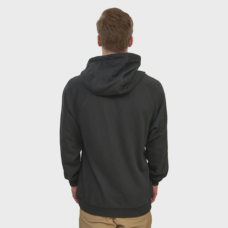 May include: A dark gray hooded sweatshirt with a drawstring hood. The sweatshirt has long sleeves and a ribbed hem and cuffs. The person is wearing khaki-colored pants. The image is taken from the back.