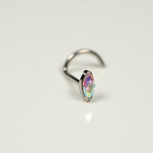 May include: A silver nose ring with a marquise-shaped iridescent gemstone.