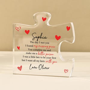 May include: Clear acrylic puzzle piece with red heart accents and personalized text. The text includes the name "Sophia" and a romantic message. A unique gift for a loved one.