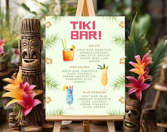 May include: A Tiki Bar sign on a wooden easel displays a menu of tropical cocktails: Mai Tai, Piña Colada, and Blue Hawaiian. The sign is decorated with palm fronds and flowers. Wooden tiki statues and colorful flowers flank the sign.