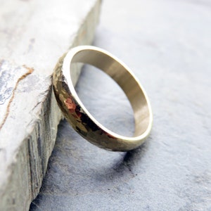 4mm heavily hammered 14k yellow gold domed wedding band.