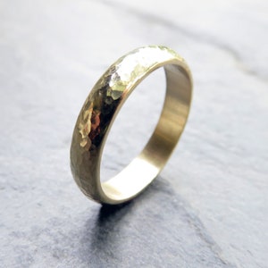 4mm heavily hammered 14k yellow gold domed wedding band.