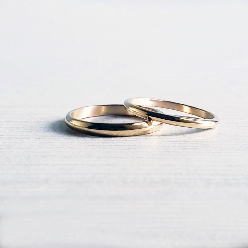 Shiny 14k yellow gold wedding rings. Classic traditional polished domed wedding band set. 3mm and 2mm D-shaped half round court profile rings.