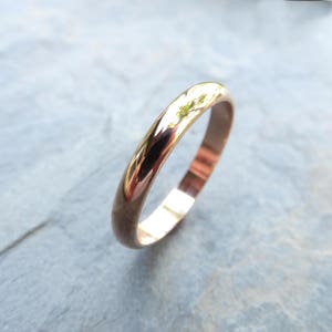 Shiny 14k yellow gold wedding ring. Classic traditional polished domed wedding band. 3mm D-shaped half round court profile ring.