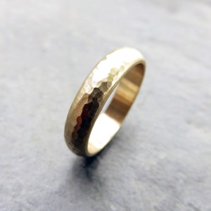 Rustic primitive matte finish 4mm heavily hammered 14k yellow gold domed wedding band.