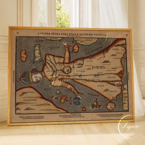 May include: A framed vintage map of Europe in a unique human form. The map features detailed illustrations, text, and a color palette of beige, brown, and blue. The text includes "EVROPA PRIMA PARS TERRE IN FORMA VIRGINIS". The frame is gold.