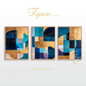 May include: Three framed abstract art prints with geometric shapes in shades of blue, gold, and white. The prints are arranged in a row and feature a modern, minimalist design.